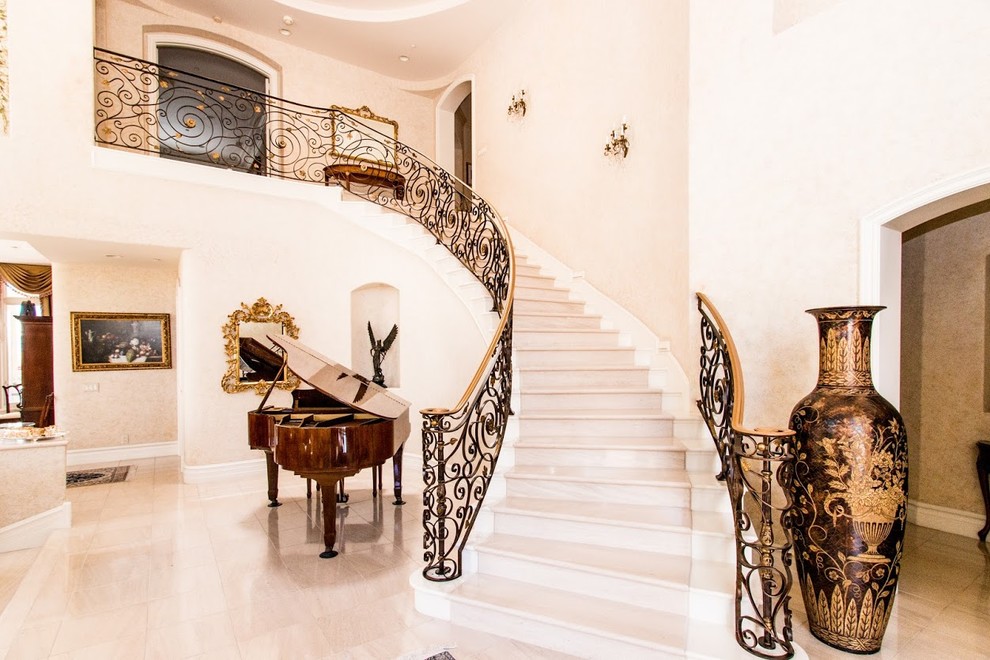 Design ideas for a large mediterranean tile curved staircase in Orange County with tile risers.