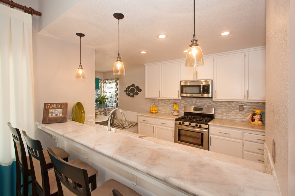 Kitchen - mid-sized transitional kitchen idea in Sacramento with flat-panel cabinets, white cabinets, granite countertops and glass tile backsplash
