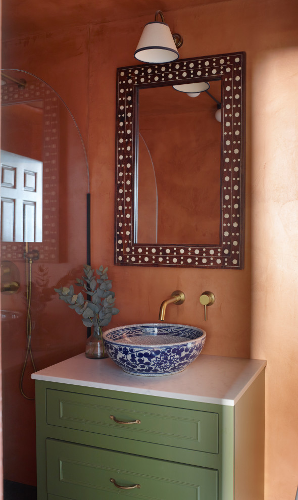Mediterranean bathroom in London with a walk-in shower, orange tiles, cement tiles, marble worktops, white worktops and a single sink.