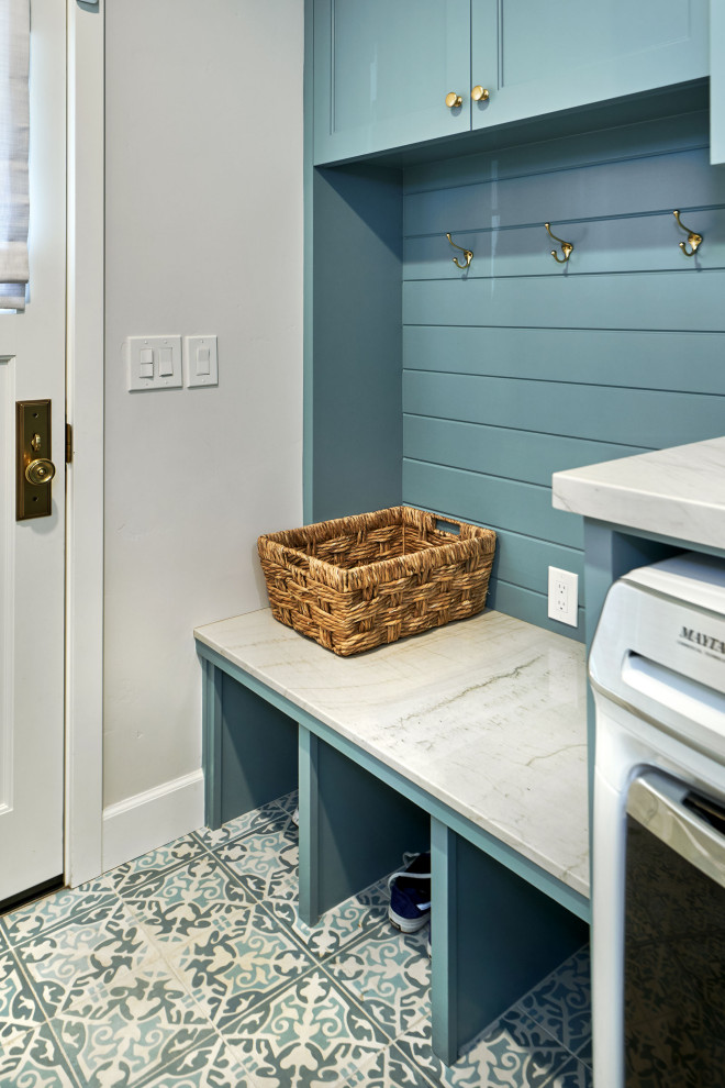 Mid-sized transitional single-wall utility room in San Francisco with recessed-panel cabinets, blue cabinets, quartzite benchtops, white splashback, ceramic splashback, grey walls, porcelain floors, a side-by-side washer and dryer, blue floor, white benchtop and planked wall panelling.