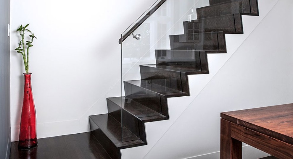 Photo of a contemporary wood straight staircase in Denver with wood risers and glass railing.