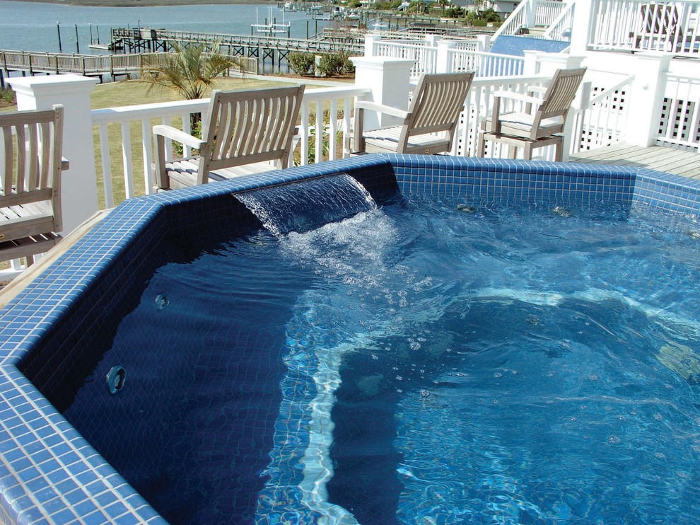 Design ideas for a beach style backyard aboveground pool in Other with a hot tub and decking.