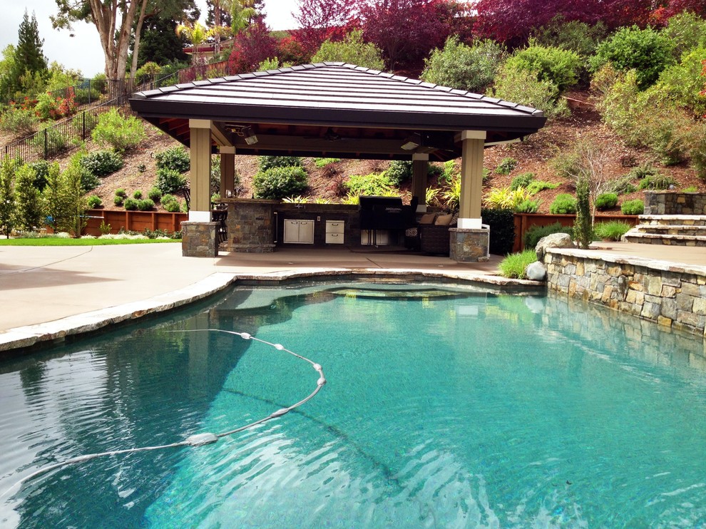 Photo of a mid-sized traditional backyard patio in San Francisco with an outdoor kitchen, natural stone pavers and a gazebo/cabana.