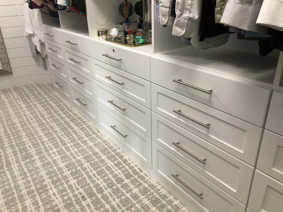 Design ideas for a mid-sized country gender-neutral walk-in wardrobe in Other with shaker cabinets, white cabinets, carpet and white floor.