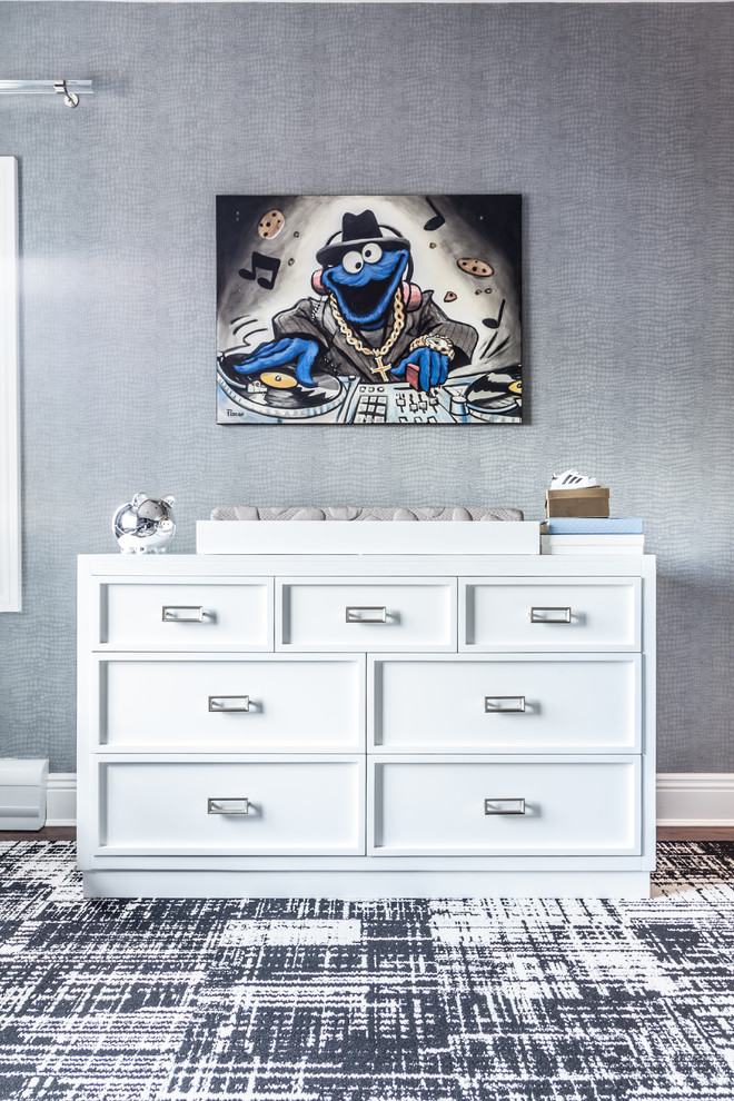 Mid-sized minimalist boy dark wood floor nursery photo in New York with blue walls