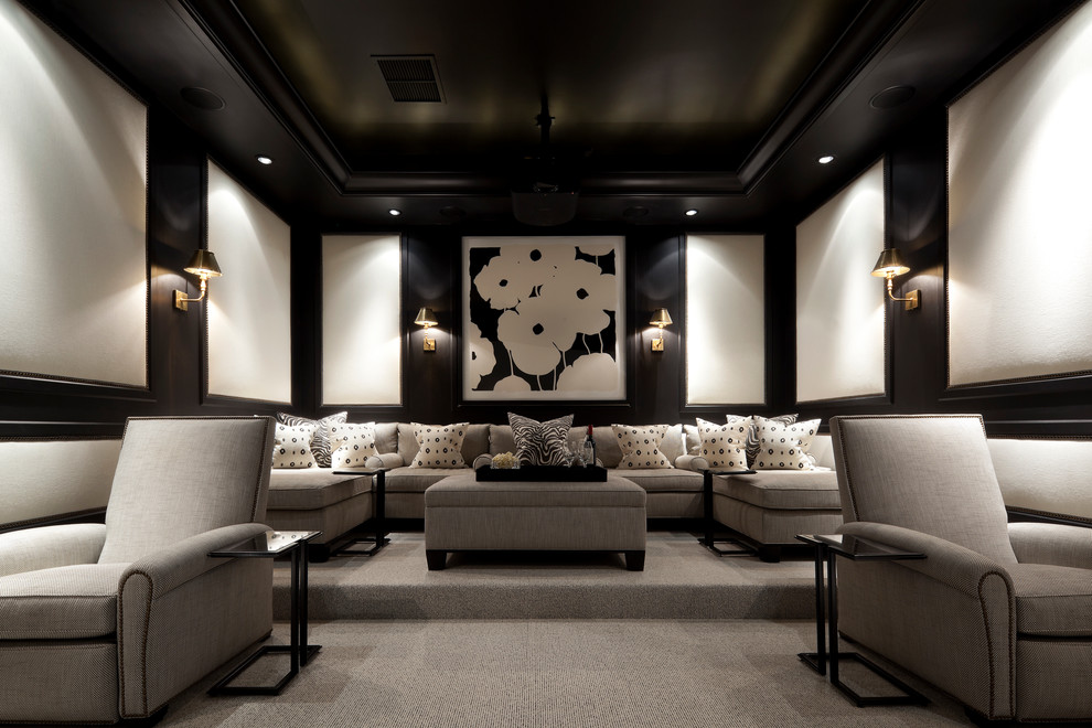 Large traditional enclosed home theatre in Miami with black walls, carpet, a projector screen and grey floor.