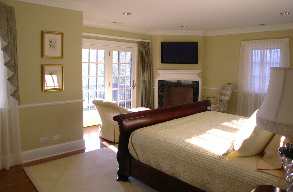 Mid-sized traditional master bedroom in Other with green walls, medium hardwood floors, a corner fireplace and a stone fireplace surround.