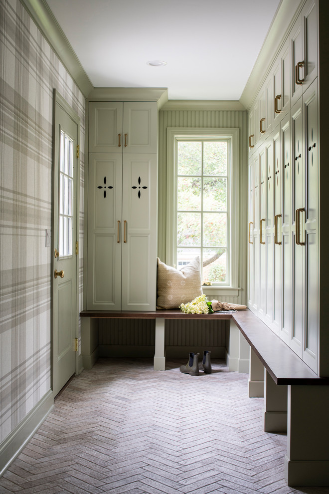 Inspiration for a mid-sized transitional mudroom in Minneapolis with green walls, a green front door, wallpaper, porcelain floors and multi-coloured floor.