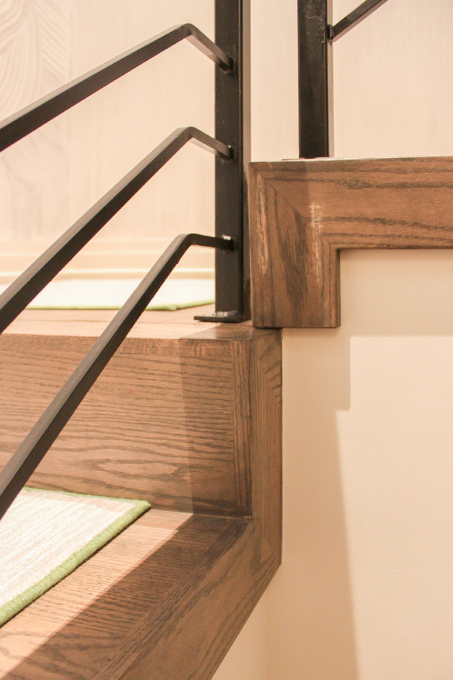 Photo of a large eclectic wood floating staircase in DC Metro with wood risers and metal railing.