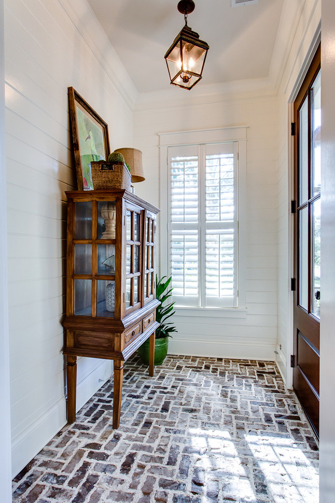 Inspiration for a traditional vestibule in Charleston with brick floors.