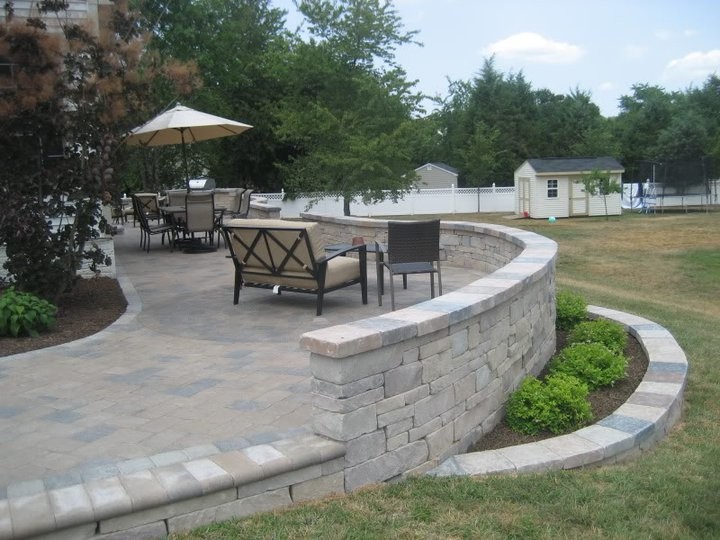 Photo of a mid-sized traditional backyard patio in DC Metro with tile and no cover.