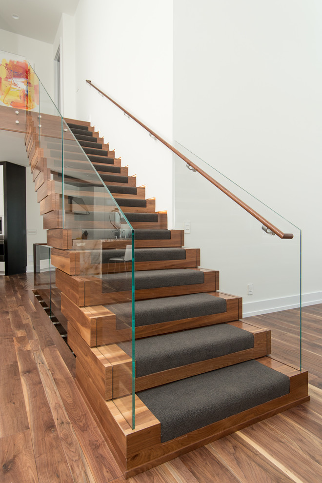 Staircase - large modern wooden floating staircase idea in Cleveland with wooden risers