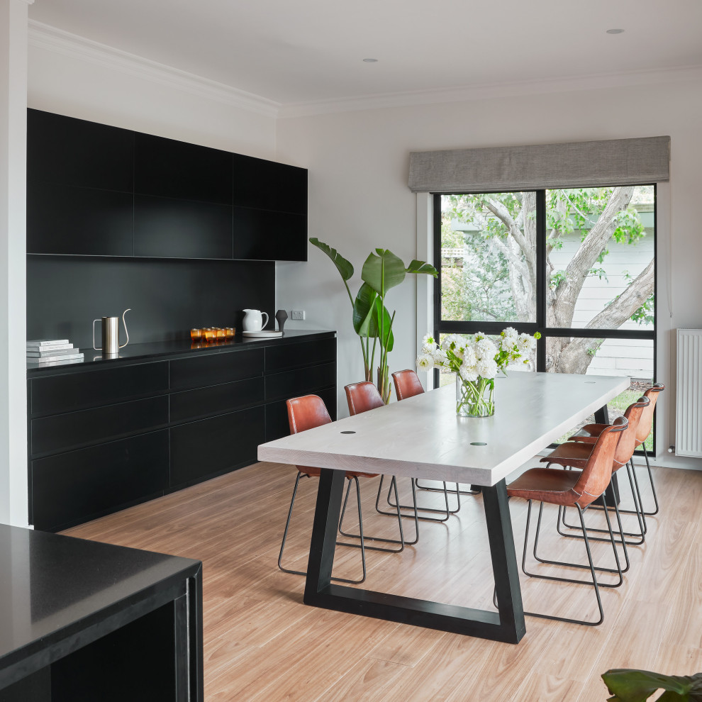 Inspiration for a contemporary light wood floor and beige floor dining room remodel in Melbourne