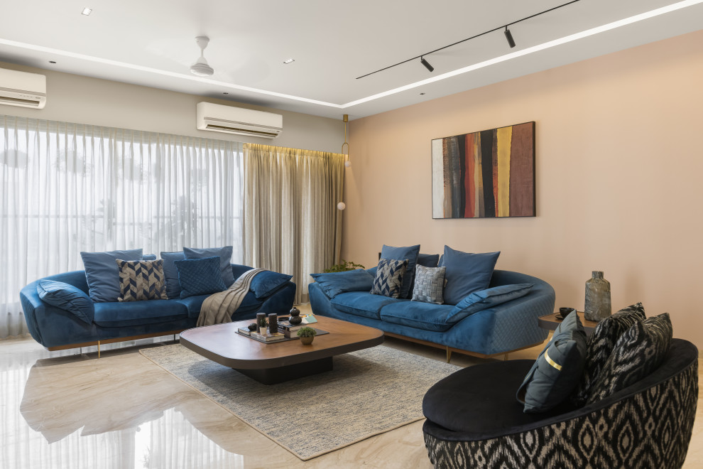 This is an example of a large modern formal open concept living room in Mumbai with grey walls, marble floors, a wall-mounted tv, beige floor and panelled walls.