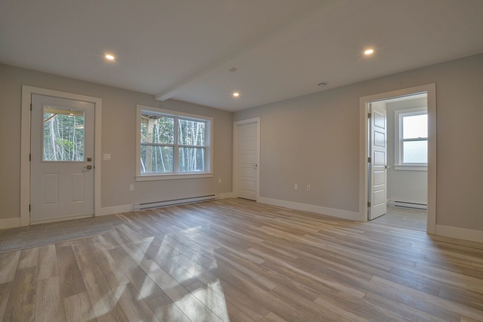 Basement - mid-sized transitional walk-out beige floor basement idea with gray walls