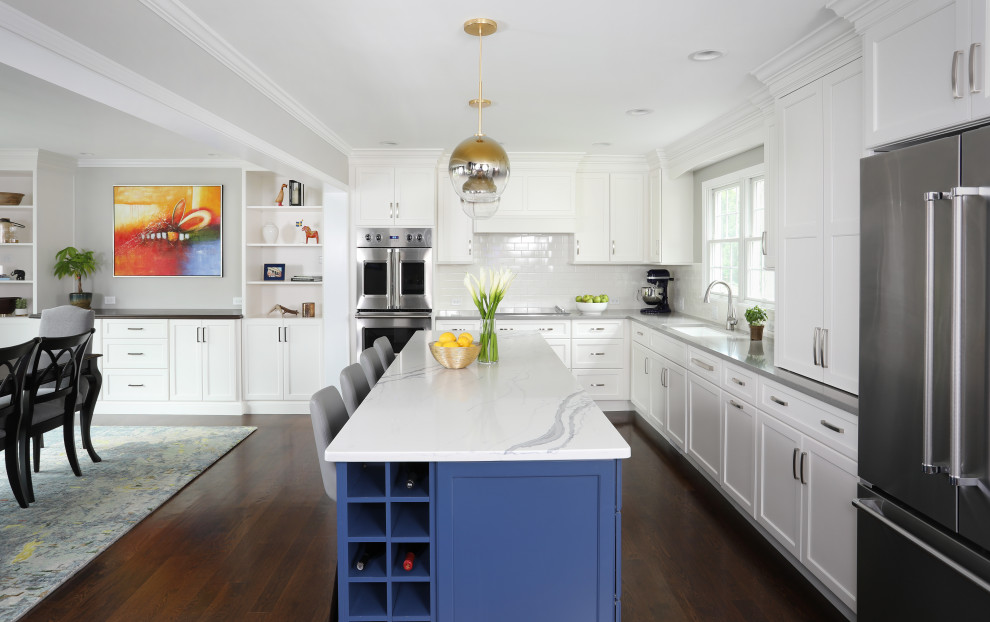 Example of a huge transitional l-shaped dark wood floor and brown floor eat-in kitchen design in Chicago with an undermount sink, shaker cabinets, white cabinets, quartzite countertops, white backsplash, porcelain backsplash, stainless steel appliances, an island and gray countertops