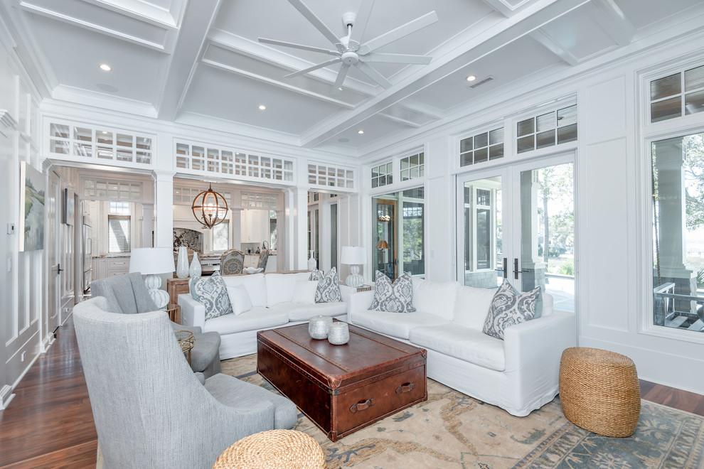 Inspiration for a beach style living room in Charleston with white walls, dark hardwood floors and brown floor.