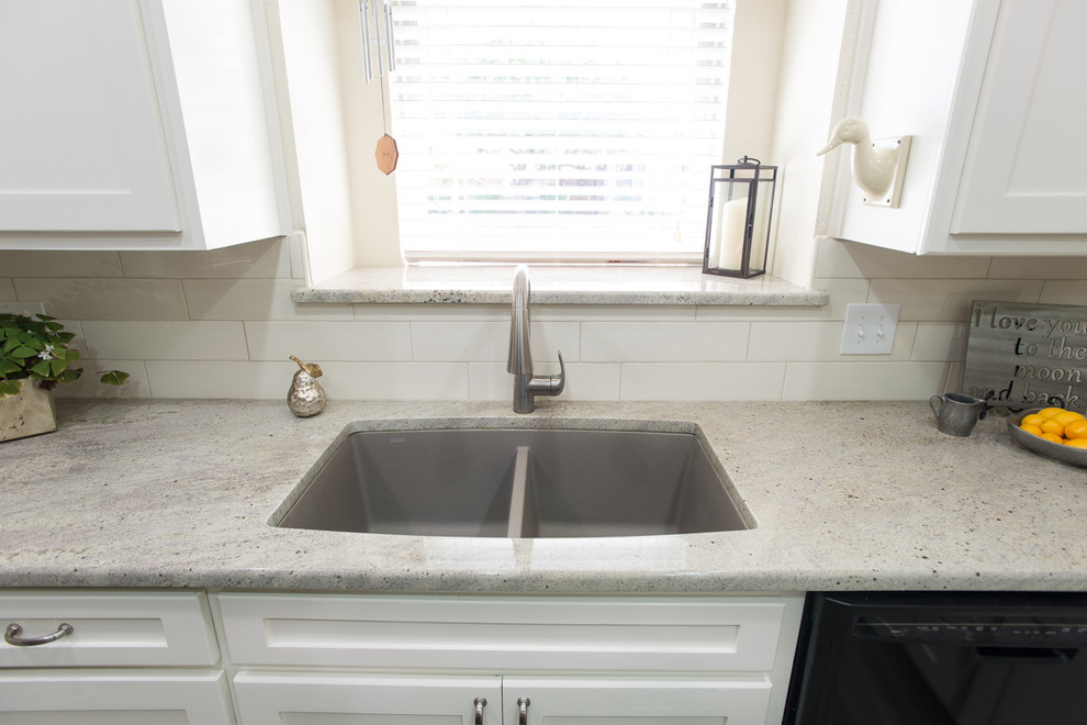 Eat-in kitchen - small transitional l-shaped ceramic tile eat-in kitchen idea in Dallas with a drop-in sink, recessed-panel cabinets, white cabinets, white backsplash, subway tile backsplash, black appliances and an island