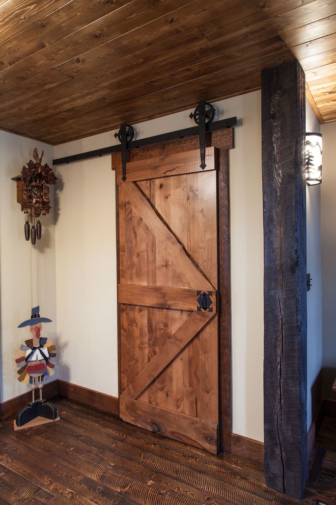 Hallway - small rustic dark wood floor hallway idea with beige walls