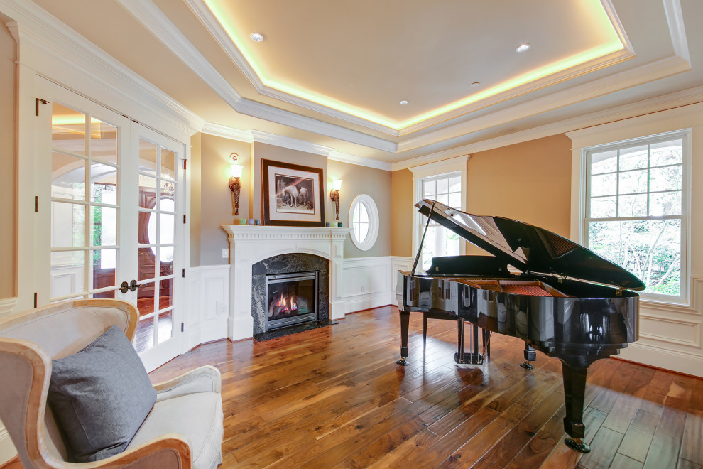 Inspiration for a large traditional open concept family room in Seattle with a music area, brown walls, medium hardwood floors, a standard fireplace, recessed and decorative wall panelling.