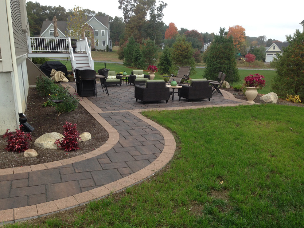 Inspiration for a mid-sized contemporary side yard patio in Boston with stamped concrete and no cover.