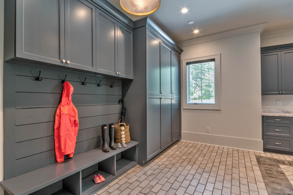 This is an example of a large transitional u-shaped utility room in Atlanta with a drop-in sink, shaker cabinets, white cabinets, laminate benchtops, white walls, ceramic floors, a side-by-side washer and dryer, white floor, white benchtop and planked wall panelling.