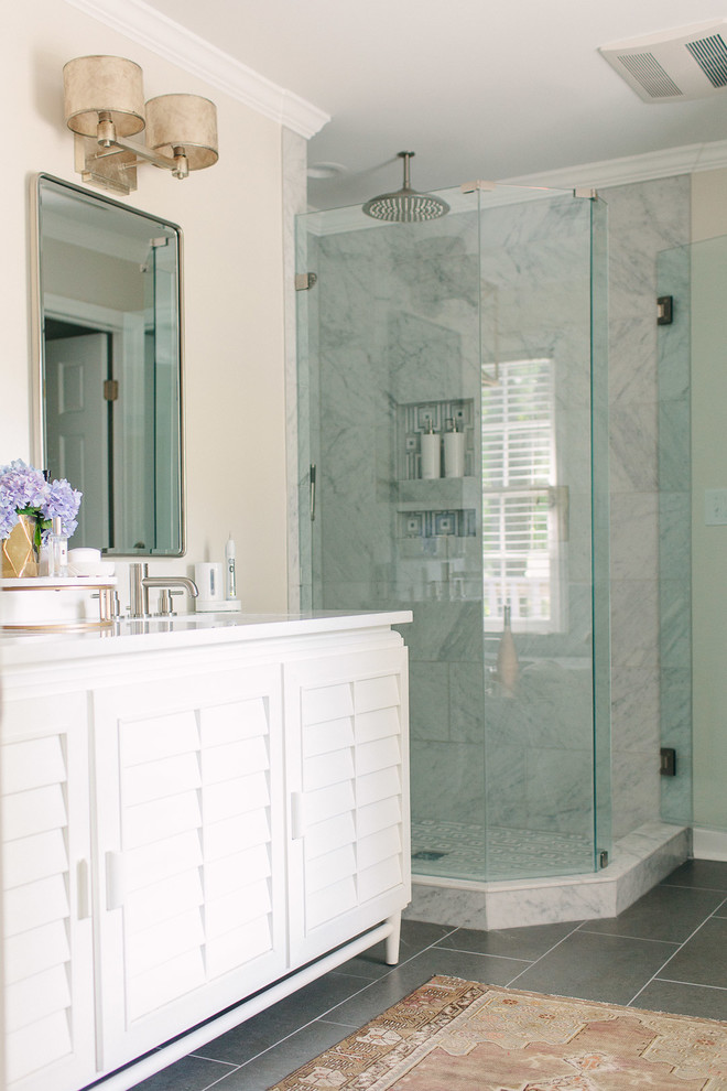 Inspiration for a mid-sized traditional master bathroom in Charlotte with louvered cabinets, white cabinets, a freestanding tub, a corner shower, a one-piece toilet, grey walls, ceramic floors, an undermount sink, engineered quartz benchtops, grey floor, a hinged shower door and white benchtops.