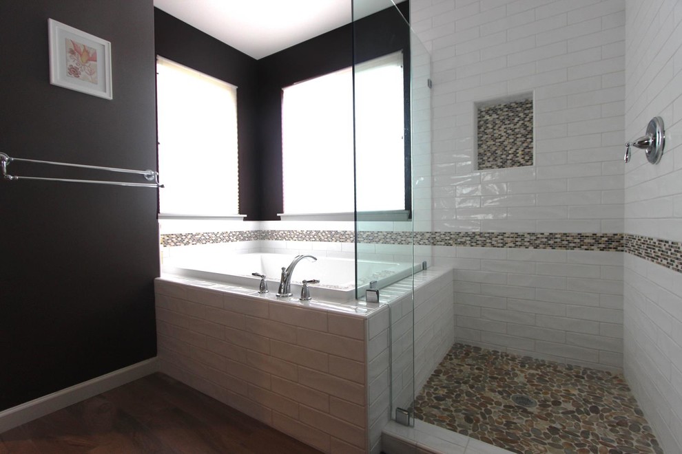 Inspiration for a mid-sized contemporary master bathroom in Seattle with an undermount sink, shaker cabinets, light wood cabinets, solid surface benchtops, a drop-in tub, a corner shower, a one-piece toilet, white tile, porcelain tile, brown walls and porcelain floors.