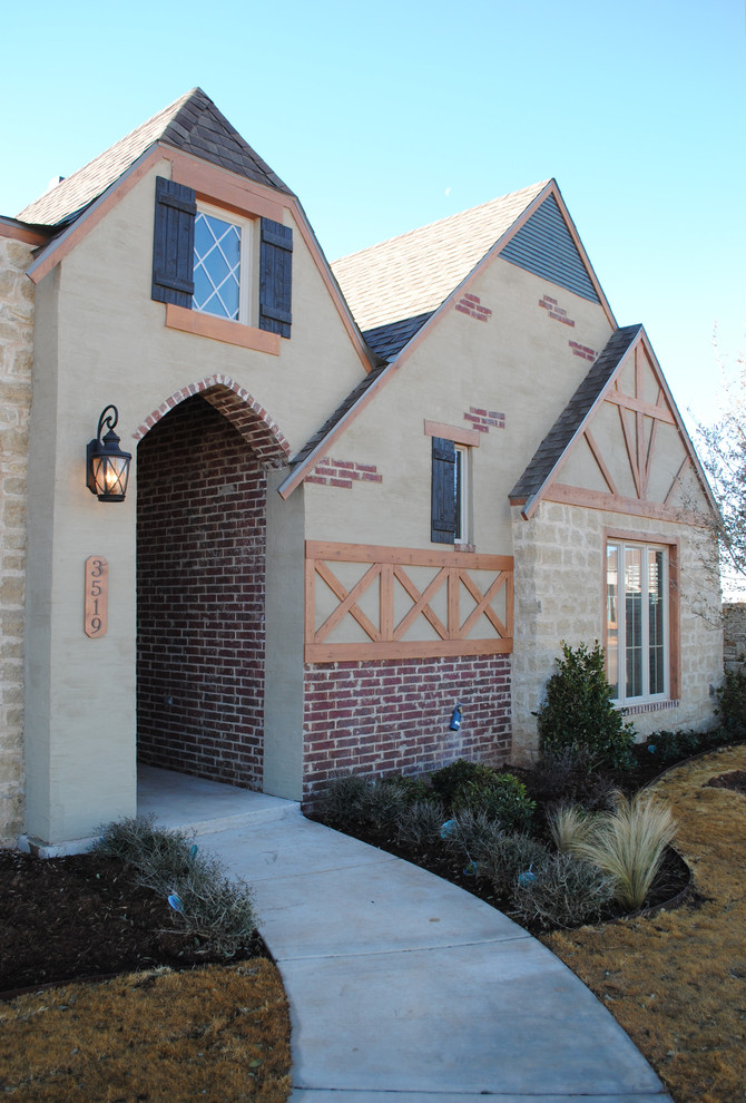Photo of a large eclectic one-storey brick red exterior in Austin with a gable roof.