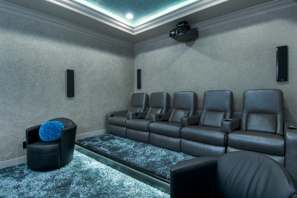 Design ideas for a mid-sized eclectic enclosed home theatre in Tampa with carpet, a projector screen and blue floor.