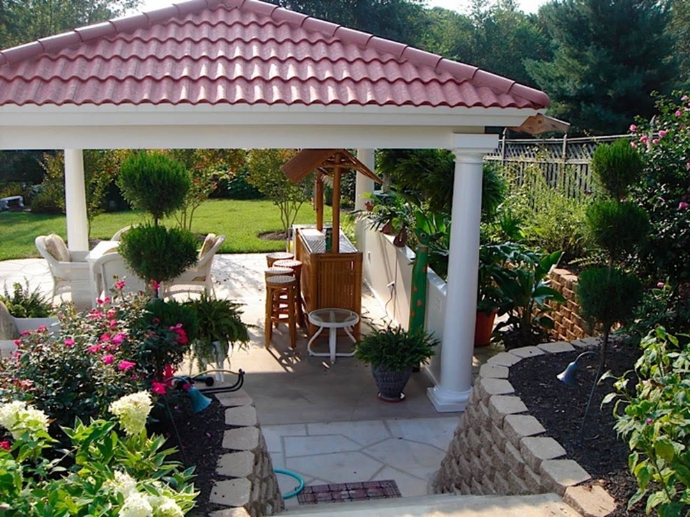 Large transitional backyard patio photo in DC Metro with a roof extension