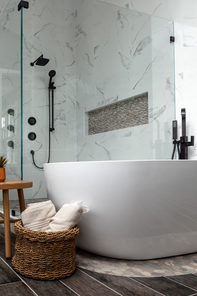 Inspiration for a large modern master porcelain tile, gray floor, double-sink and vaulted ceiling freestanding bathtub remodel in Philadelphia with recessed-panel cabinets, gray cabinets, a two-piece toilet, gray walls, an undermount sink, quartzite countertops, a hinged shower door, white countertops and a built-in vanity