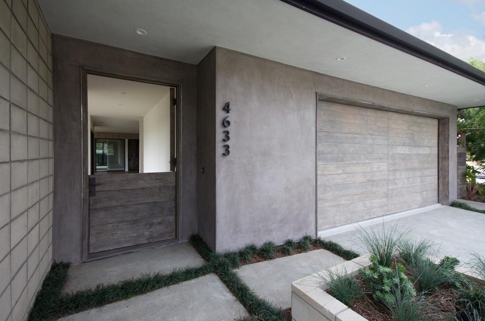 Photo of a mid-sized midcentury front door in Los Angeles with a dutch front door and a light wood front door.