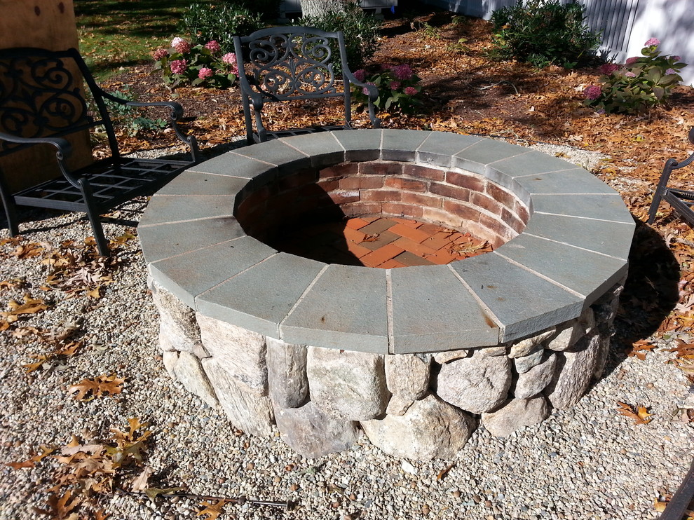 Mid-sized traditional backyard patio in Boston with a fire feature, gravel and no cover.
