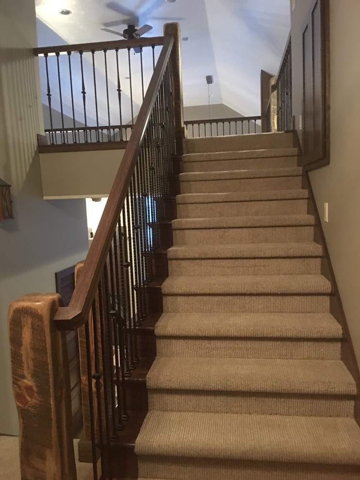 Inspiration for a large rustic carpeted straight staircase remodel with wooden risers