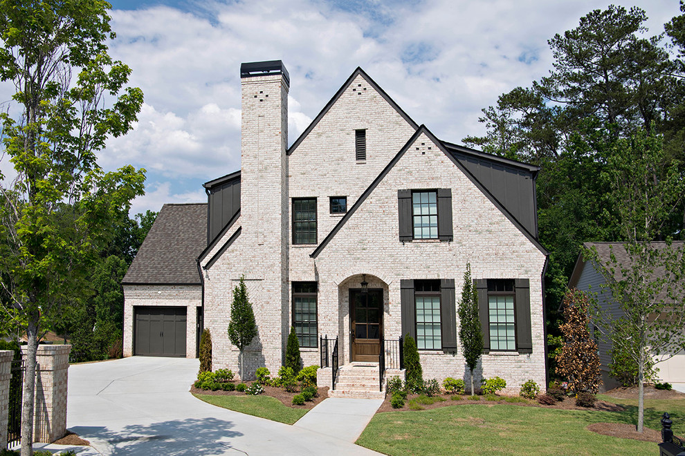 This is an example of a mid-sized traditional three-storey brick beige exterior in Atlanta with a hip roof.
