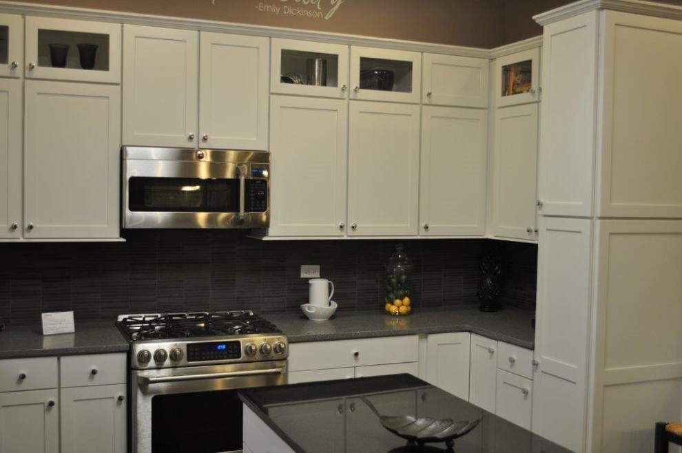 Mid-sized transitional l-shaped kitchen photo in Chicago with shaker cabinets, white cabinets, stainless steel appliances and an island