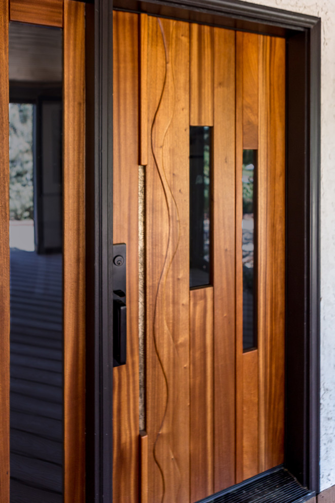 Photo of a contemporary front door in Denver with a single front door and a medium wood front door.