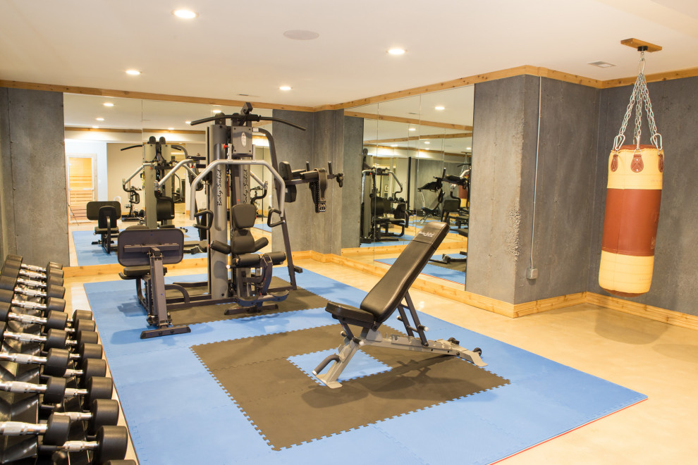 This is an example of a mid-sized transitional home weight room in Chicago with grey walls, concrete floors and beige floor.