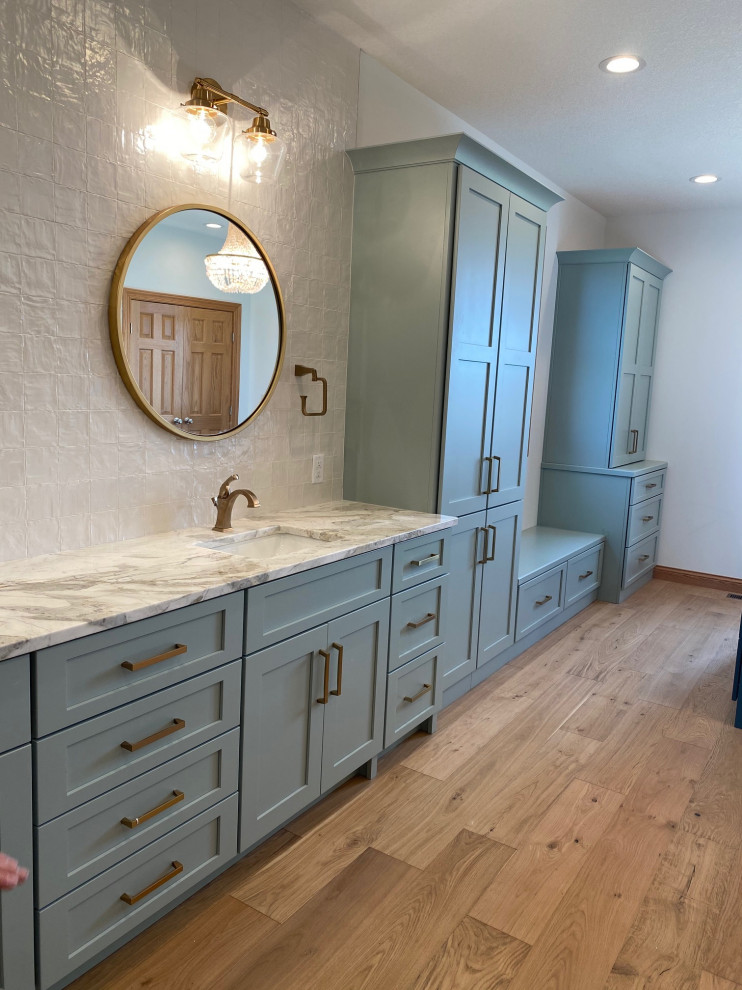 Design ideas for an expansive transitional master bathroom in Other with shaker cabinets, green cabinets, light hardwood floors, marble benchtops, brown floor, a double vanity and a built-in vanity.