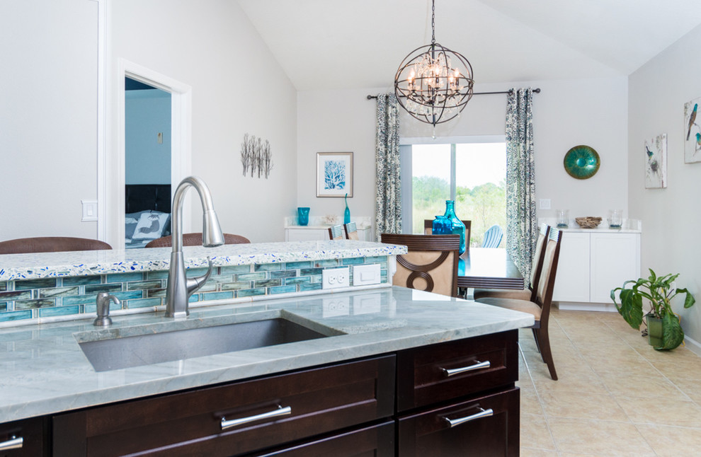 Inspiration for a small transitional galley ceramic tile eat-in kitchen remodel in Orlando with shaker cabinets, quartzite countertops, gray backsplash, stone tile backsplash, stainless steel appliances, white cabinets and a peninsula