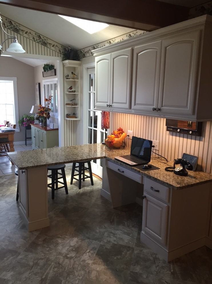 Small transitional l-shaped eat-in kitchen photo with raised-panel cabinets, beige cabinets, granite countertops and a peninsula