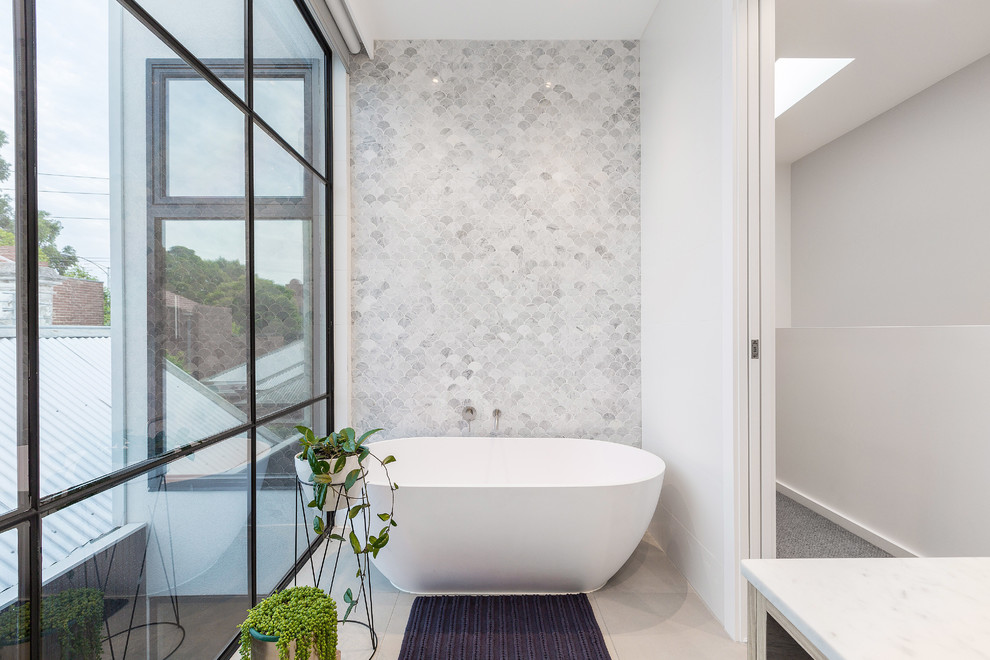 Inspiration for a mid-sized contemporary master wet room bathroom in Melbourne with light wood cabinets, a freestanding tub, white tile, mosaic tile, white walls, porcelain floors, marble benchtops, grey floor, a hinged shower door and white benchtops.