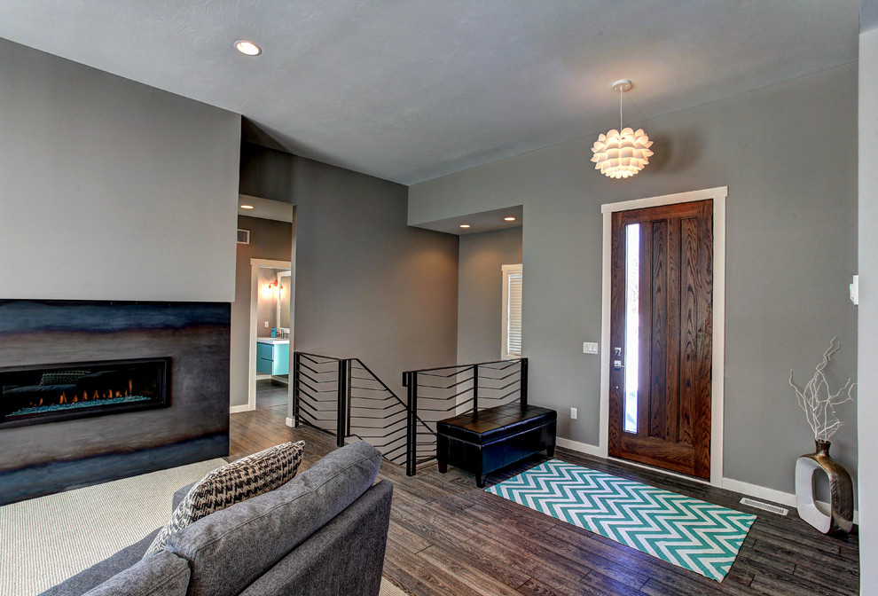 Photo of a modern living room in Grand Rapids with grey walls, a ribbon fireplace and a metal fireplace surround.