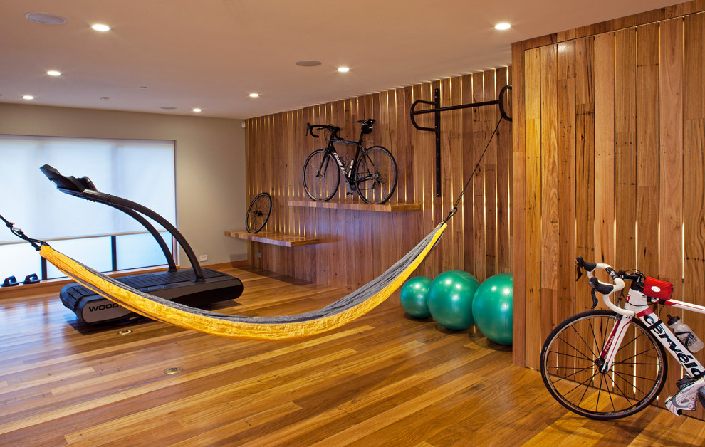 Design ideas for a mid-sized contemporary multipurpose gym in San Francisco with medium hardwood floors, brown walls and yellow floor.