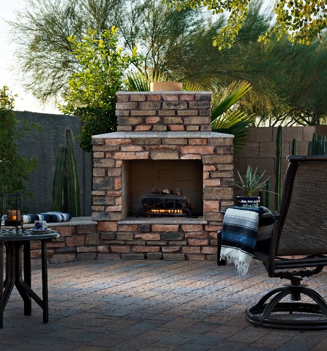 Large mediterranean backyard patio in Phoenix with a fire feature and concrete pavers.