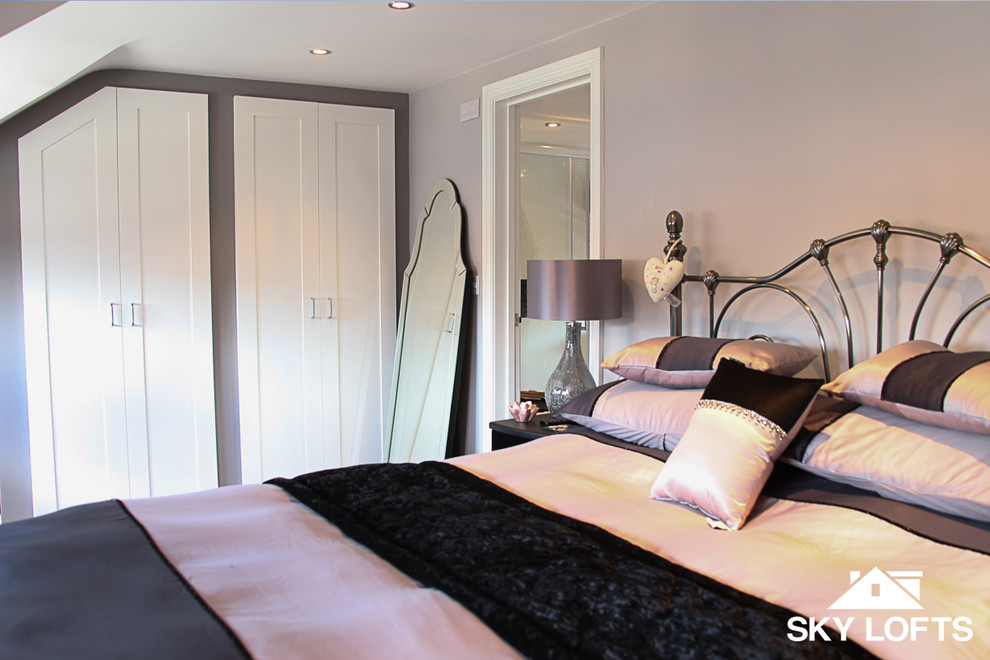 This is an example of a mid-sized modern loft-style bedroom in Hampshire.