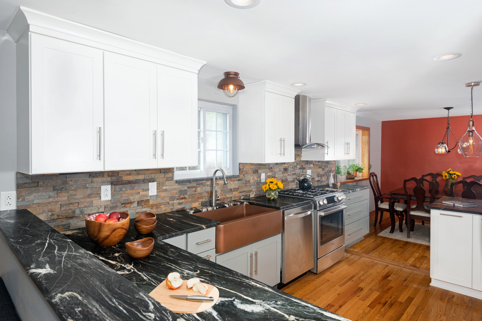Eat-in kitchen - mid-sized transitional u-shaped medium tone wood floor and beige floor eat-in kitchen idea with a farmhouse sink, shaker cabinets, gray cabinets, marble countertops, multicolored backsplash, stone tile backsplash, stainless steel appliances, a peninsula and black countertops
