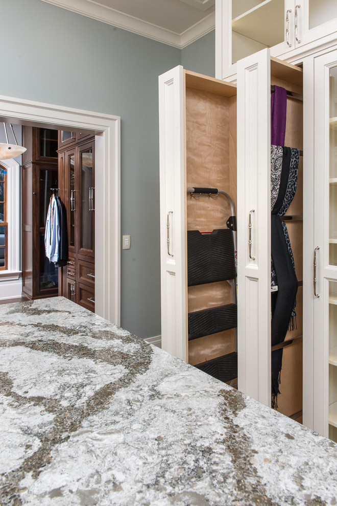 Large transitional women's dressing room in Charleston with dark hardwood floors, recessed-panel cabinets and white cabinets.