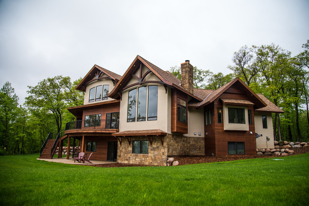 Example of a transitional three-story mixed siding gable roof design in Minneapolis with a shingle roof